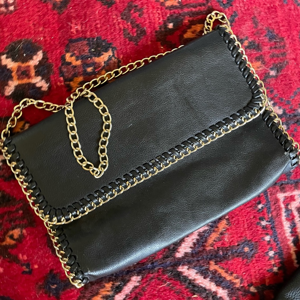 Black Leather clutch with gold colored chain strap.